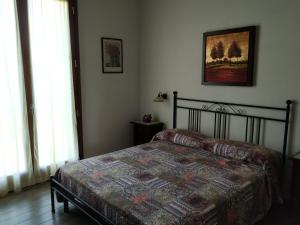 a bedroom with a bed and a picture on the wall at La Valle in Villa Verucchio +13 photos