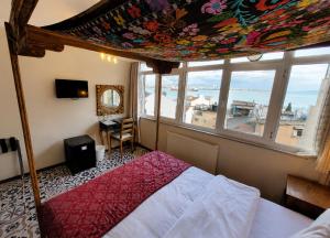 a bedroom with a bed and a large window at Marmara Guesthouse in Istanbul