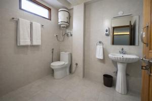 a bathroom with a toilet and a sink at The Sana Cottge, Manali - Affordable Luxury Stay in Manali in Manāli