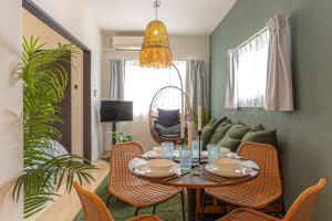 a dining room with a table and chairs and a couch at Otter Stay - Masaki in Nagoya
