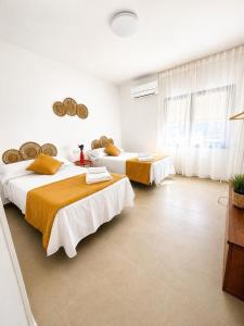 two beds in a room with white walls at CasaConchaGuadamur in Guadamur