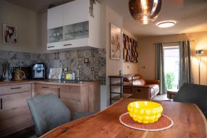 a kitchen with a wooden table with a yellow bowl on it at Spanisches Haus in Staßfurt