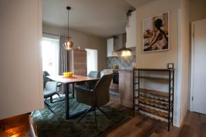 a kitchen and dining room with a table and chairs at Spanisches Haus in Staßfurt