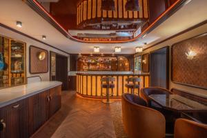 a bar in a room with a table and chairs at Hôtel La Bourdonnais by Inwood Hotels in Paris +39 photos