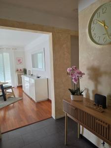 a living room with a large clock on the wall at Le repos de Cézanne in Salon-de-Provence +1 photo
