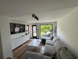 a living room with a couch and a tv at U Paňmamky in Šakvice