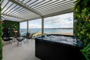 a hot tub on a patio with a view of the ocean at The blue Mirage II in Tangier