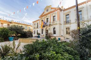 a large building with flags in front of it at L'interlude in Amélie-les-Bains-Palalda