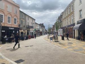 a man walking down a street in a town at Olivers retreat in Braintree