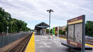a train station with a platform and a train track at Olivers retreat in Braintree