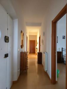 a hallway with white walls and a wooden floor at Alfredo II Affittacamere in Siena