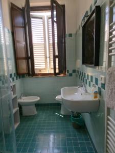 a bathroom with a sink and a toilet at Alfredo II Affittacamere in Siena +9 photos
