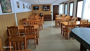 a dining room with wooden tables and chairs at Ferienzentrum Briesensee in Neu Zauche