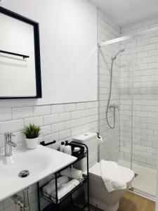 a bathroom with a toilet and a sink and a shower at Alegoría Coliving Experience in Seville +86 photos