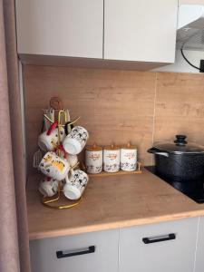 a shelf with tea pots and candles on a kitchen counter at Karagay resort in Bosteri +1 photo