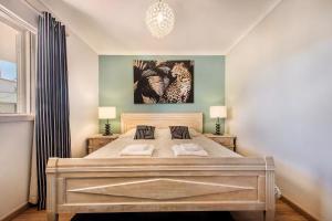 a bedroom with a large bed with two pillows at Apartamento Alquimia by Algarve Holidays in Vale do Lobo +34 photos