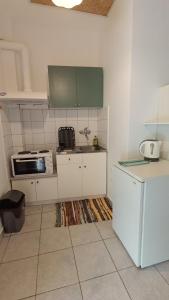 a kitchen with white cabinets and a sink at Ferouli Residence in Rizá +20 photos