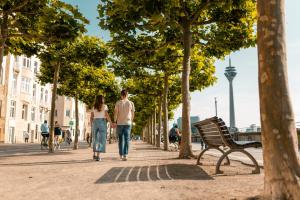 a man and a woman walking down a sidewalk at Crowne Plaza Düsseldorf - Neuss by IHG in Neuss