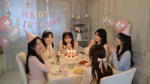 a group of women sitting around a table with a birthday cake at 핑크하우스옥상바베큐파티 in Daejeon