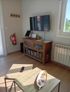 a living room with a tv and a coffee table at Casa Da Ponte in Lobios