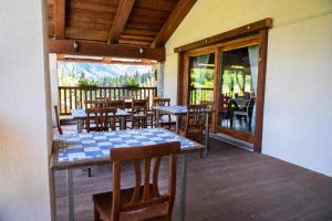 a restaurant with tables and chairs on a deck at borgo maira village in Prazzo