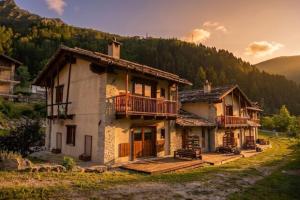 an old house with a porch and a balcony at borgo maira village in Prazzo