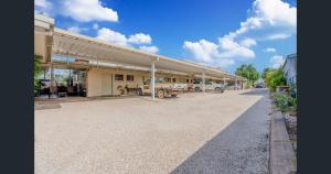 a parking lot with a car parked in a garage at A&A Lodge Motel in Emerald