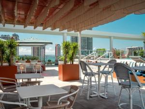 a patio with tables and chairs and a view of the city at Novotel Miami Brickell in Miami