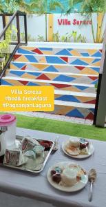 a table with two plates of food on it at Villa Seresa Room A in Pagsanjan