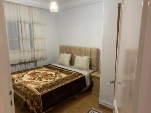 a bedroom with a bed with two pillows on it at honey moon zeinbe 4 in Hammamet