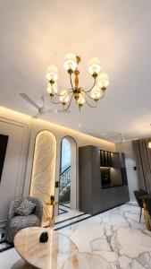 a living room with a chandelier and a table at Rivora Villa in Nashik