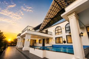 an exterior view of a house with a swimming pool at Rivora Villa in Nashik