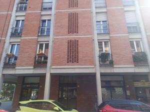 a yellow car parked in front of a building at Casa Floris in Imola +1 photo