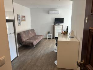 a living room with a couch and a chair at Rochavaumar in Portimão