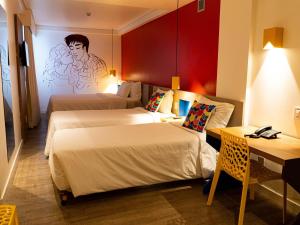 a hotel room with two beds and a desk at ibis Styles Campina Grande in Campina Grande +93 photos