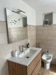 a bathroom with a sink and a toilet at Dimora Lieta in Pisticci +22 photos