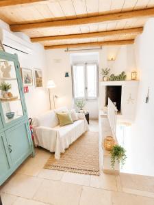 a living room with a couch and a fireplace at TorreParadiso Holidays in Polignano a Mare