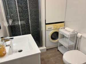a bathroom with a sink and a washing machine at Rochavaumar in Portimão +20 photos