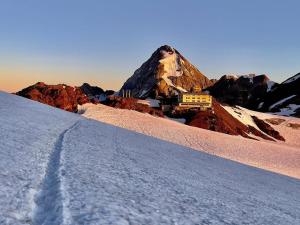 a snow covered mountain with a building on top of it at Freeabile 51 - Cevedale - stanza in centro in Sondrio
