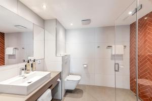 a bathroom with a sink and a toilet and a shower at Aiden by Best Western Velbert in Velbert