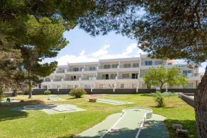 an apartment building with a playground in front of it at Hotel Vibra Riviera in San Antonio Bay