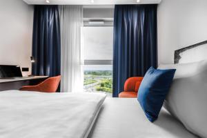 a hotel room with a bed and a window at Aiden by Best Western Velbert in Velbert +34 photos