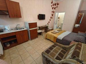 a hotel room with a bed and a sink at Shellman Apart Hotel in Odesa
