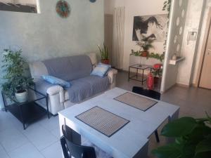 a living room with a couch and a table at Casa Floris in Imola