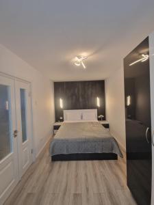 a bedroom with a large bed and a large window at Iris central Mangalia 2 bedroom apartment in Mangalia