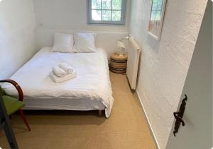 a bedroom with a bed with two towels on it at Maison de Charme,Plage et Forêt, 6 personnes in Seignosse +19 photos