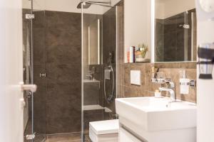 a bathroom with a shower and a sink and a toilet at Am Park 26 in Prerow