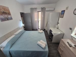 a bedroom with a large blue bed and a sink at Piazza Salotto in Corigliano Calabro