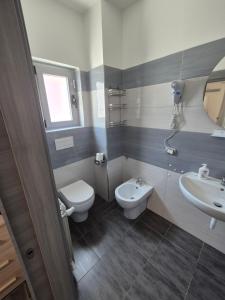 a bathroom with a toilet and a sink at Piazza Salotto in Corigliano Calabro