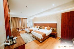 a hotel room with a bed and a desk at Hotel La Vista by Grotto Vista in Mangangpico